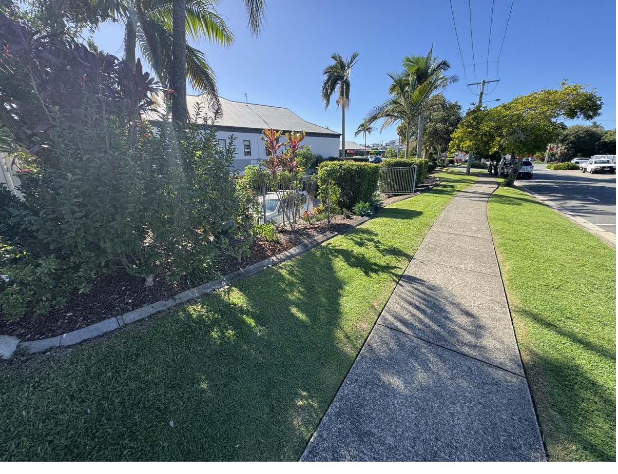 Weeded and edged garden bed beside a footpath at Mooloolaba Junction