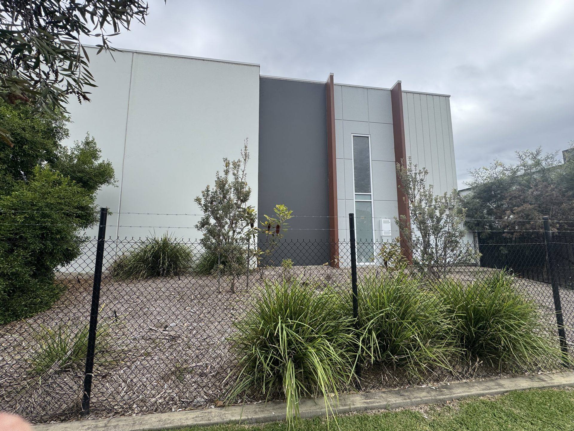 Maintained garden beds along a commercial building frontage