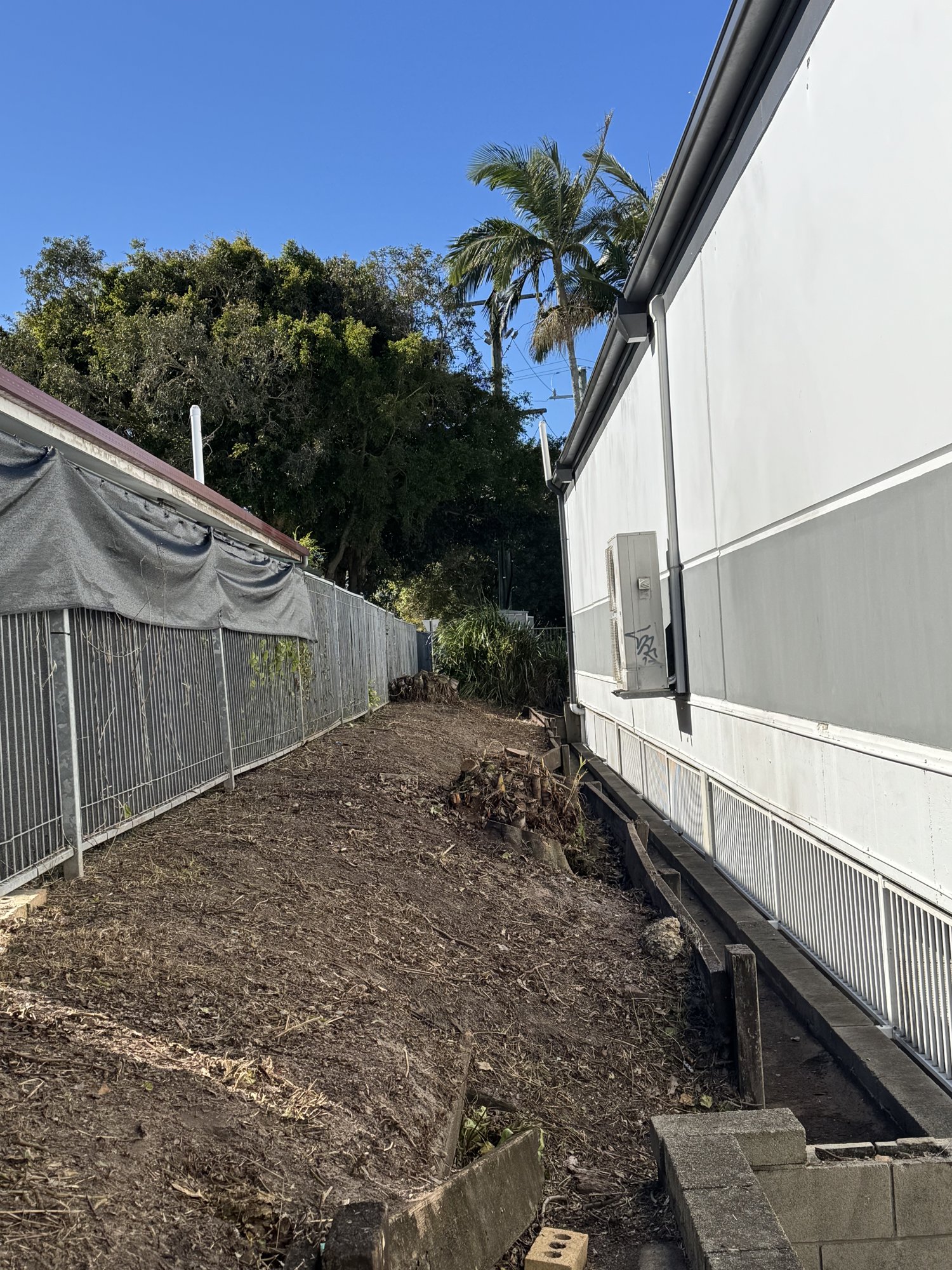 Air-conditioning units with the passage cleared back to the fence line